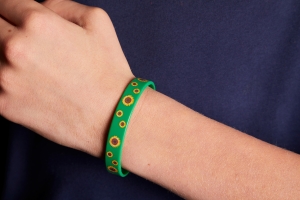 A green wristband with sunflowers